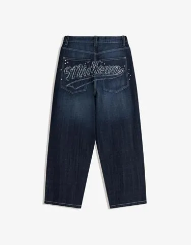 Джинсы очень свободного кроя с нашивками и заклепками- Заказать в России