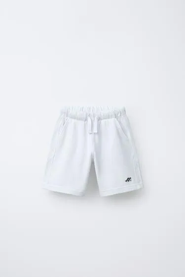 Шорты-бермуды из мягкой ткани с логотипом и декоративными вставками- Заказать в России