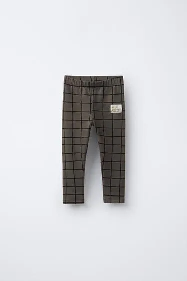 Легинсы в клетку с этикеткой