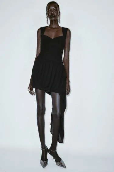 Мини-платье асимметричного кроя со сборками и низом-баллоном- Заказать в России