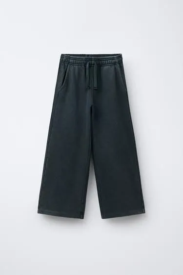 Брюки WIDE LEG с эффектом потертости, звездами и заклепками- Заказать в России