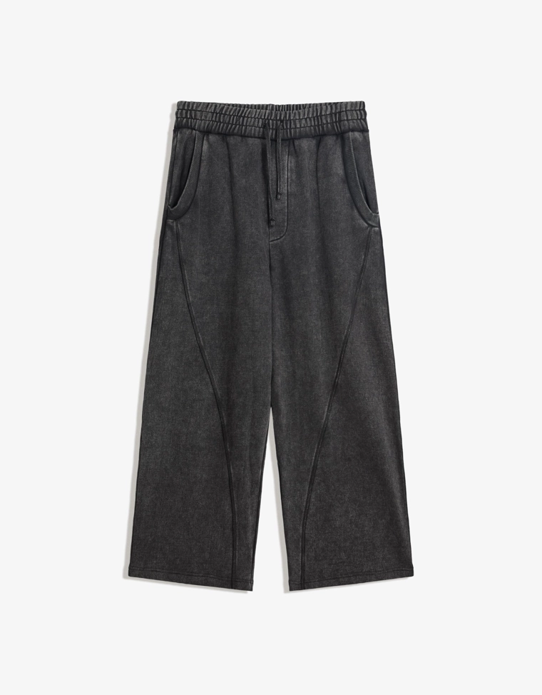 Объемные брюки свободного кроя с эффектом потертости