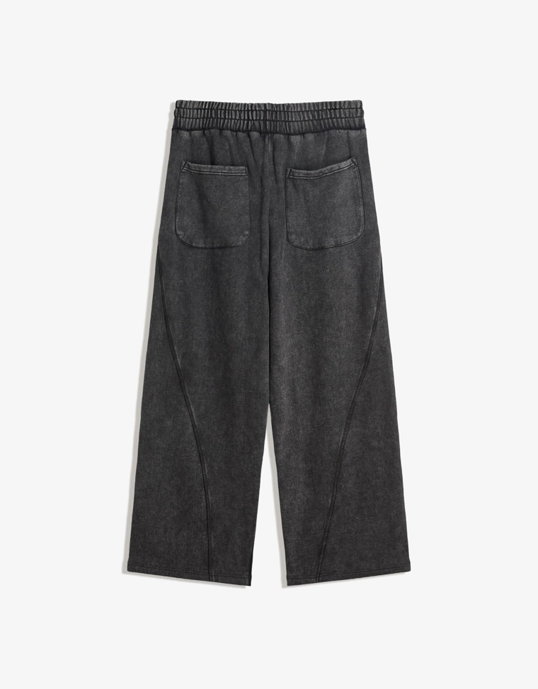 Объемные брюки свободного кроя с эффектом потертости