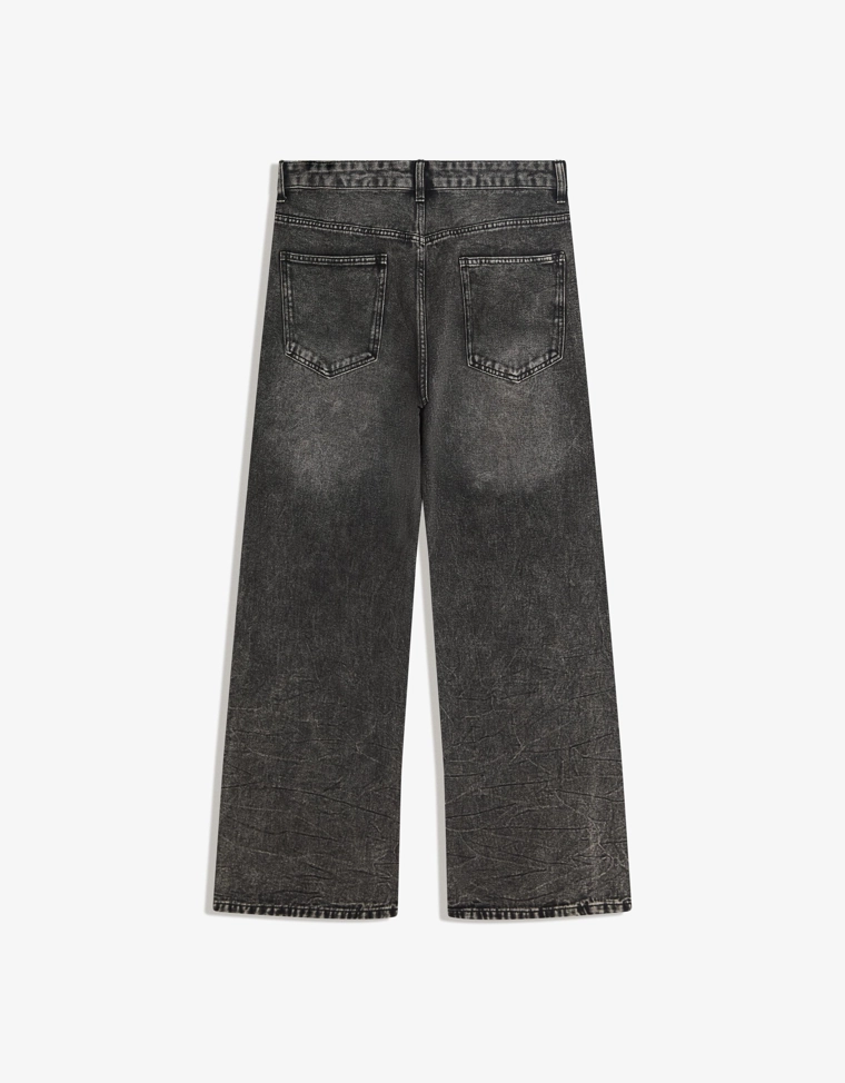 Расклешенные брюки с заклепками