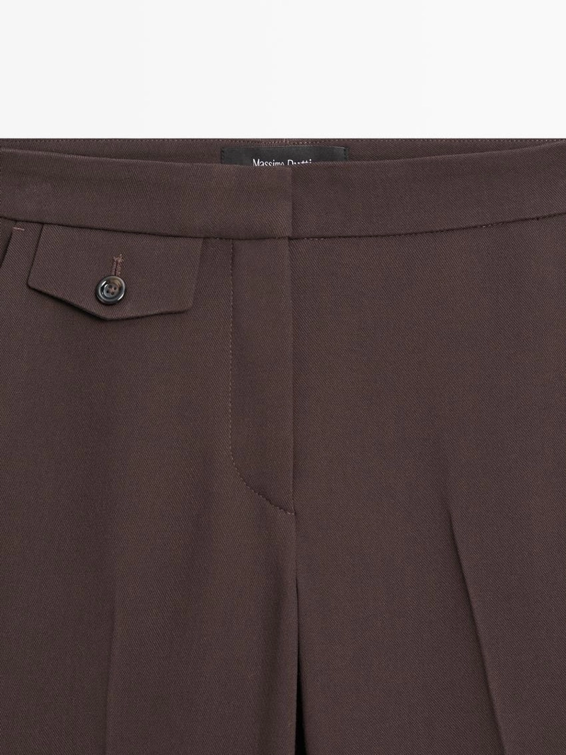 Брюки с карманами и расклешенным кроем