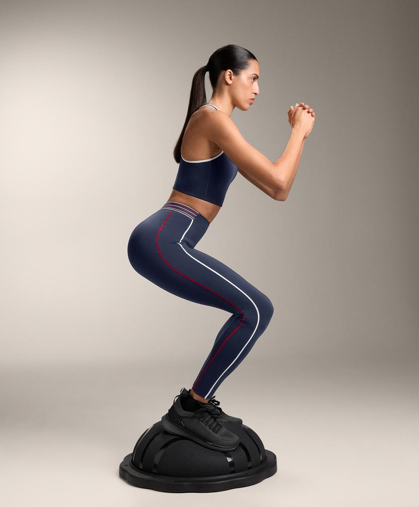 Compressive medium support sports bra with rubber cups