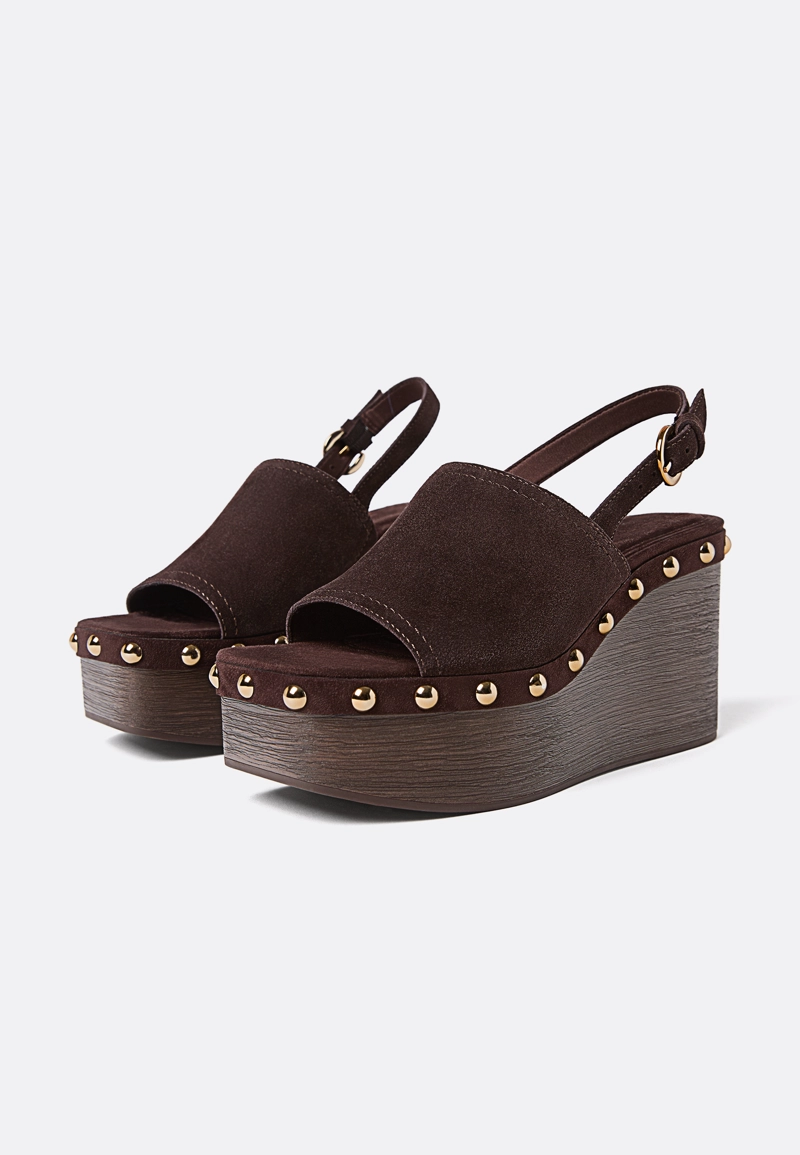 Кожаные босоножки на танкетке с заклепками