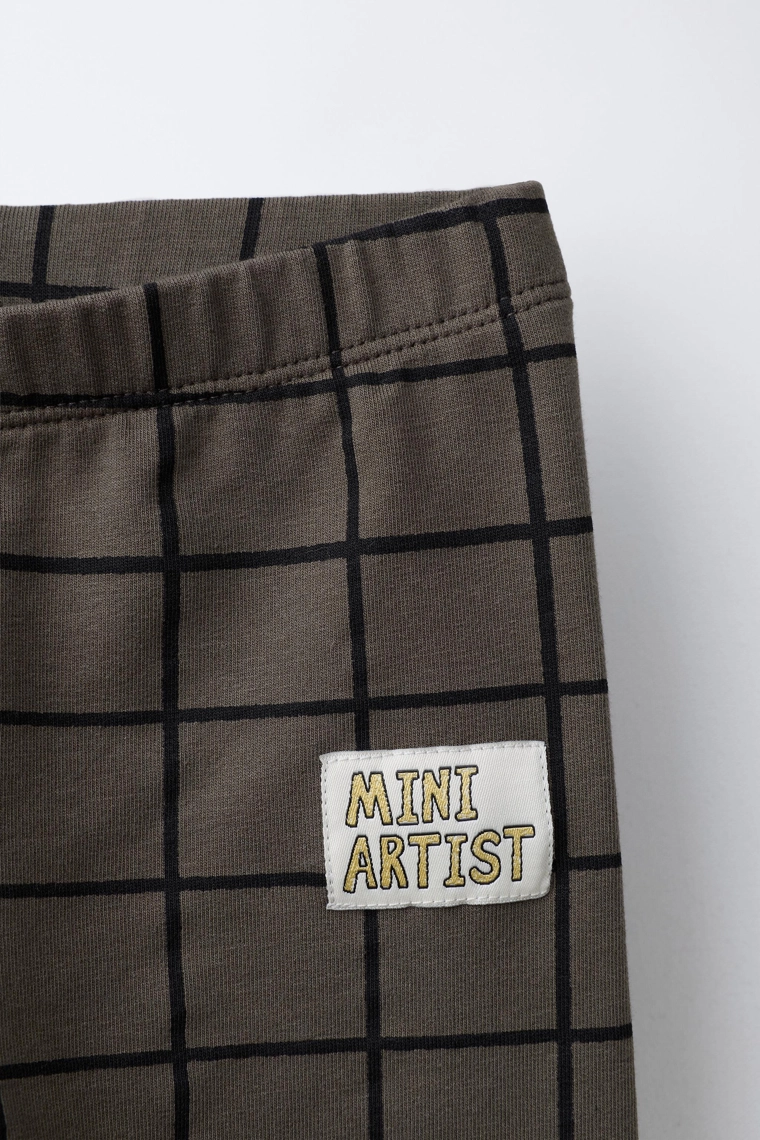 ЛЕГИНСЫ В КЛЕТКУ С ЭТИКЕТКОЙ