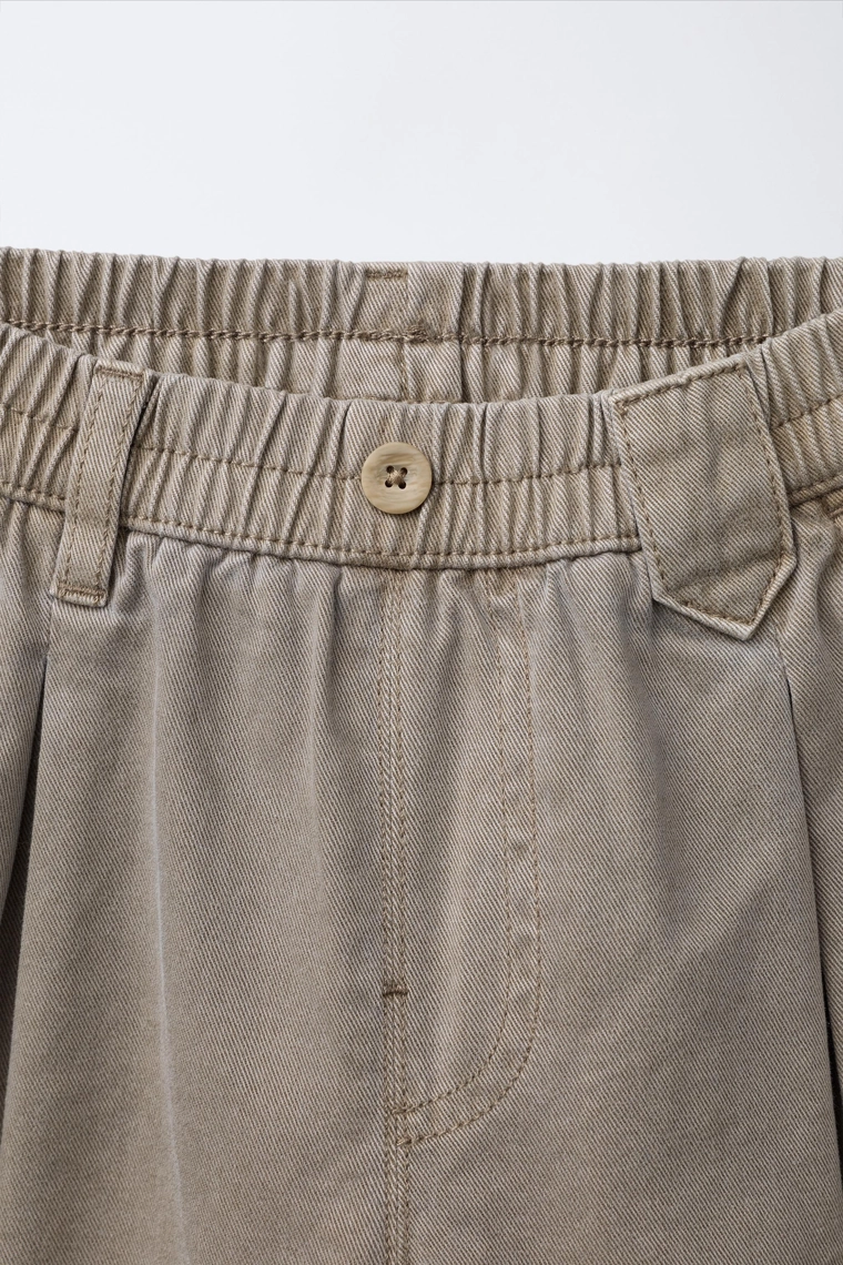 Брюки пышного покроя с отворотом