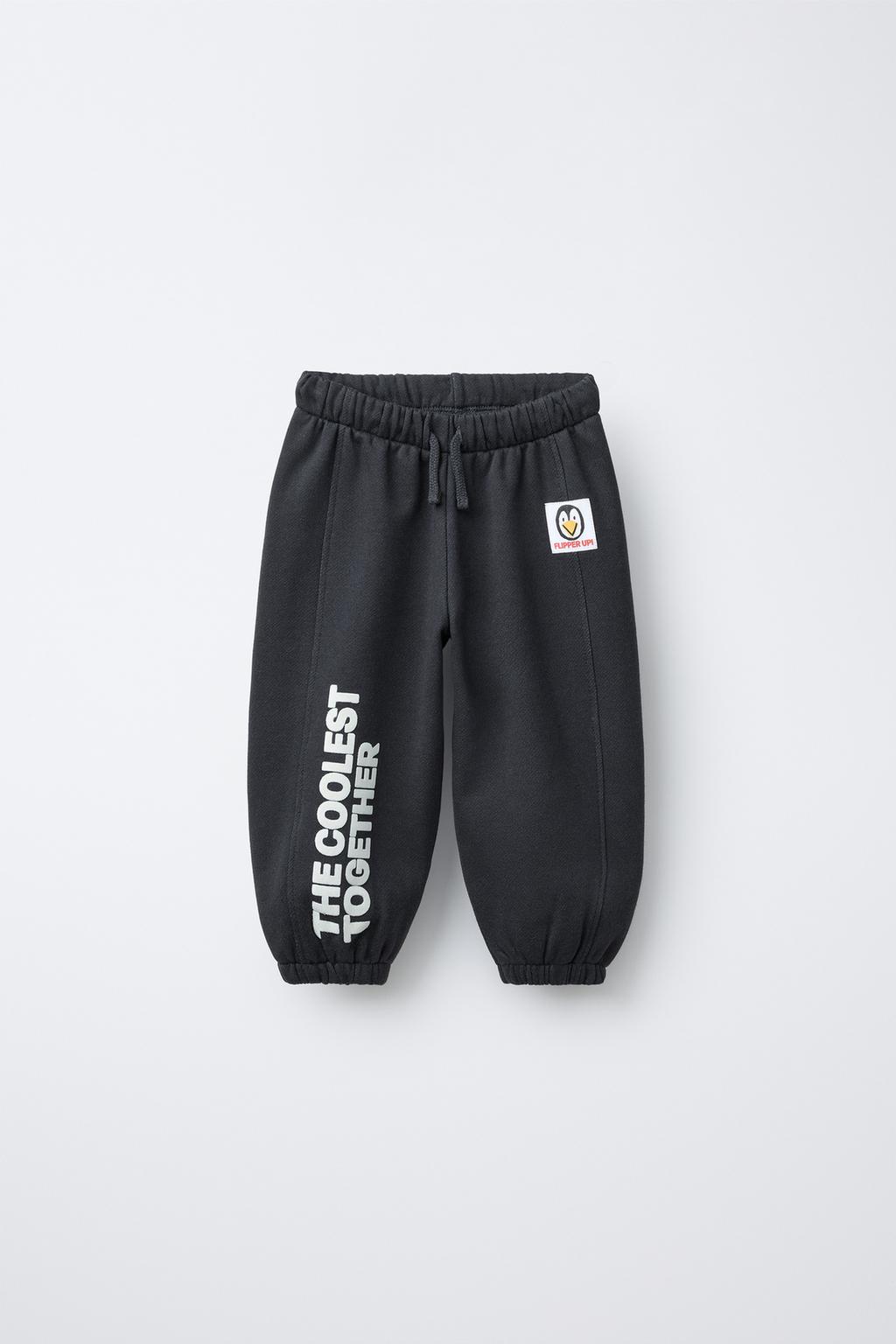 БРЮКИ-ДЖОГГЕРЫ С ТЕКСТОВЫМ ФЛОКОМ