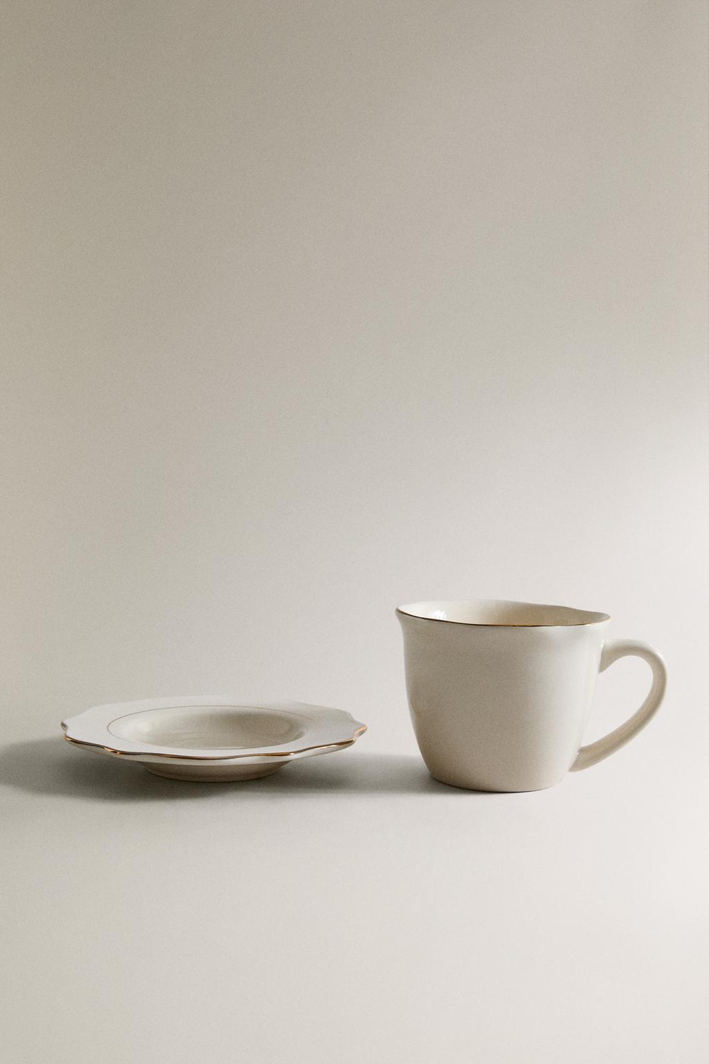 Фарфоровая чашка и блюдце с деталями на краю