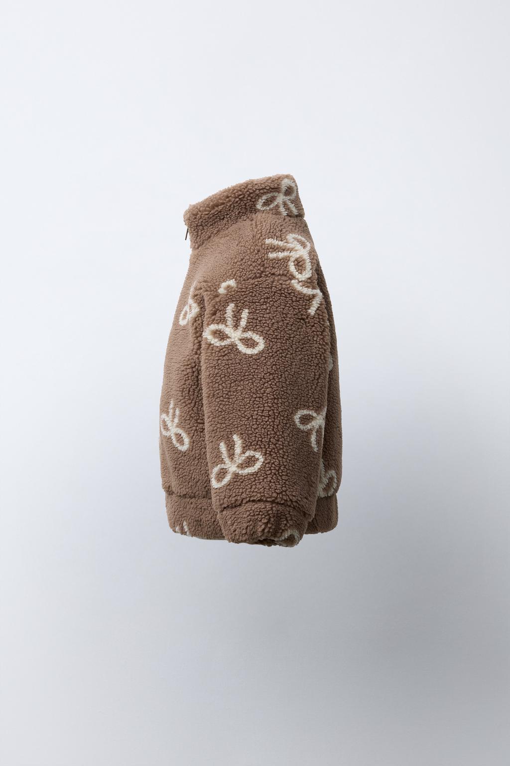 КУРТКА ИЗ ИСКУССТВЕННОЙ ОВЧИНЫ С БАНТАМИ