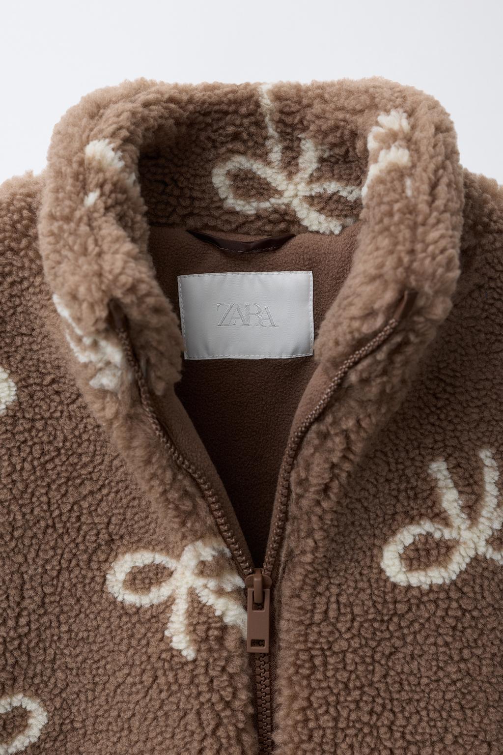 КУРТКА ИЗ ИСКУССТВЕННОЙ ОВЧИНЫ С БАНТАМИ