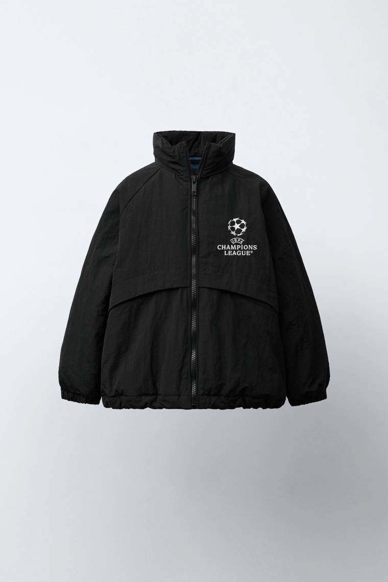 КУРТКА С ПОТАЙНЫМ КАПЮШОНОМ WATER REPELLENT UEFA CHAMPIONS LEAGUE ®