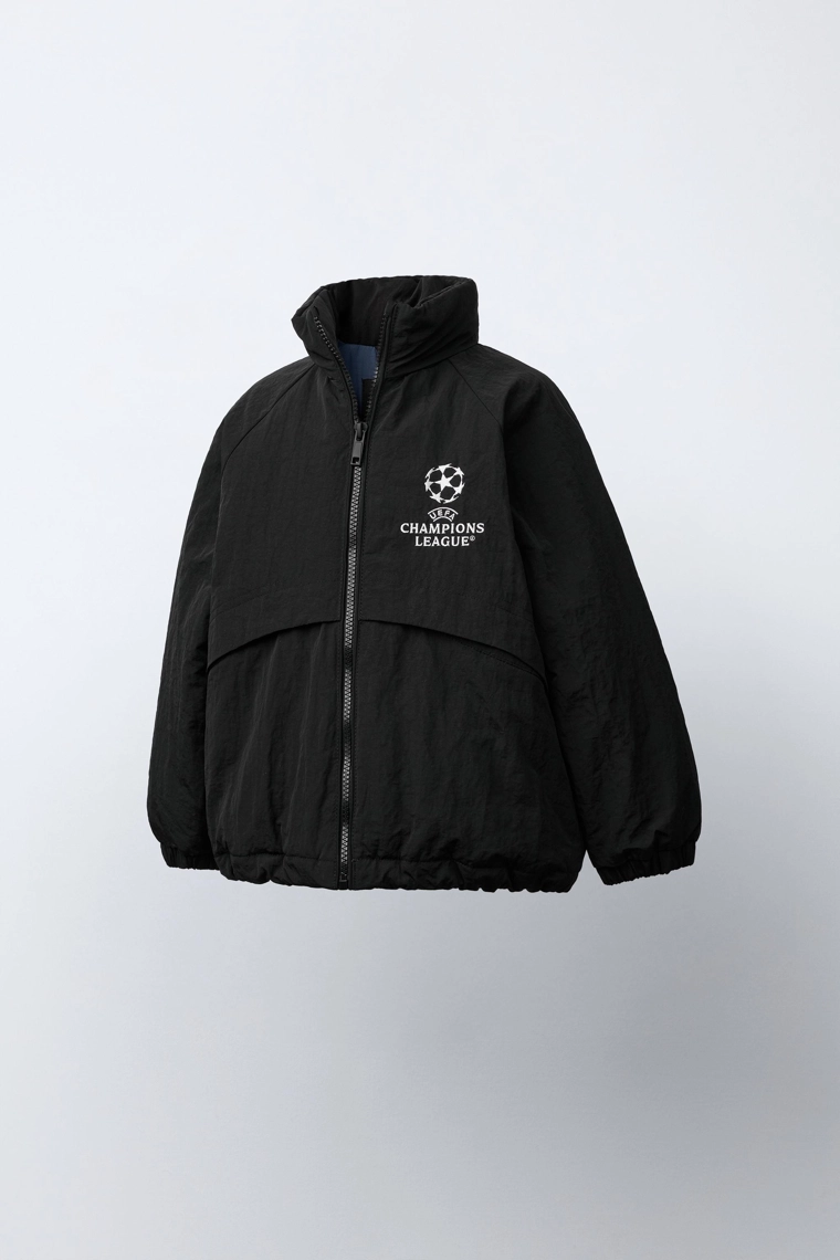 КУРТКА С ПОТАЙНЫМ КАПЮШОНОМ WATER REPELLENT UEFA CHAMPIONS LEAGUE ®